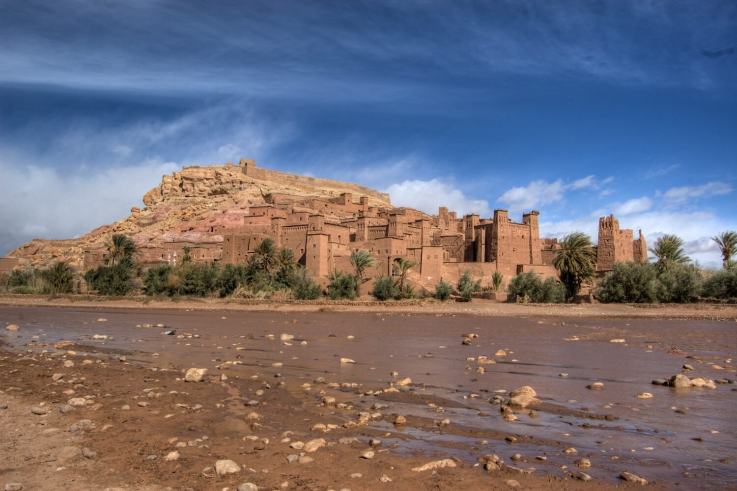 a large brown building sitting on top of a hill